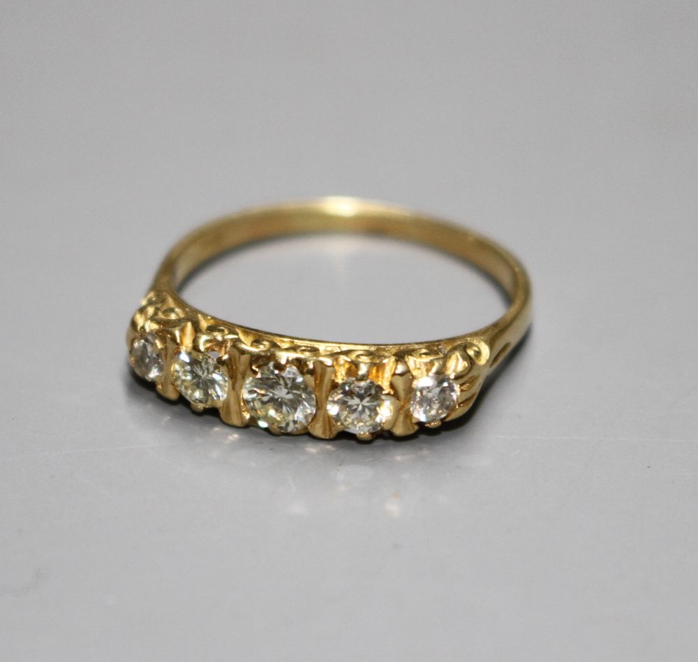 A modern 18ct gold and graduated five stone diamond half hoop ring,